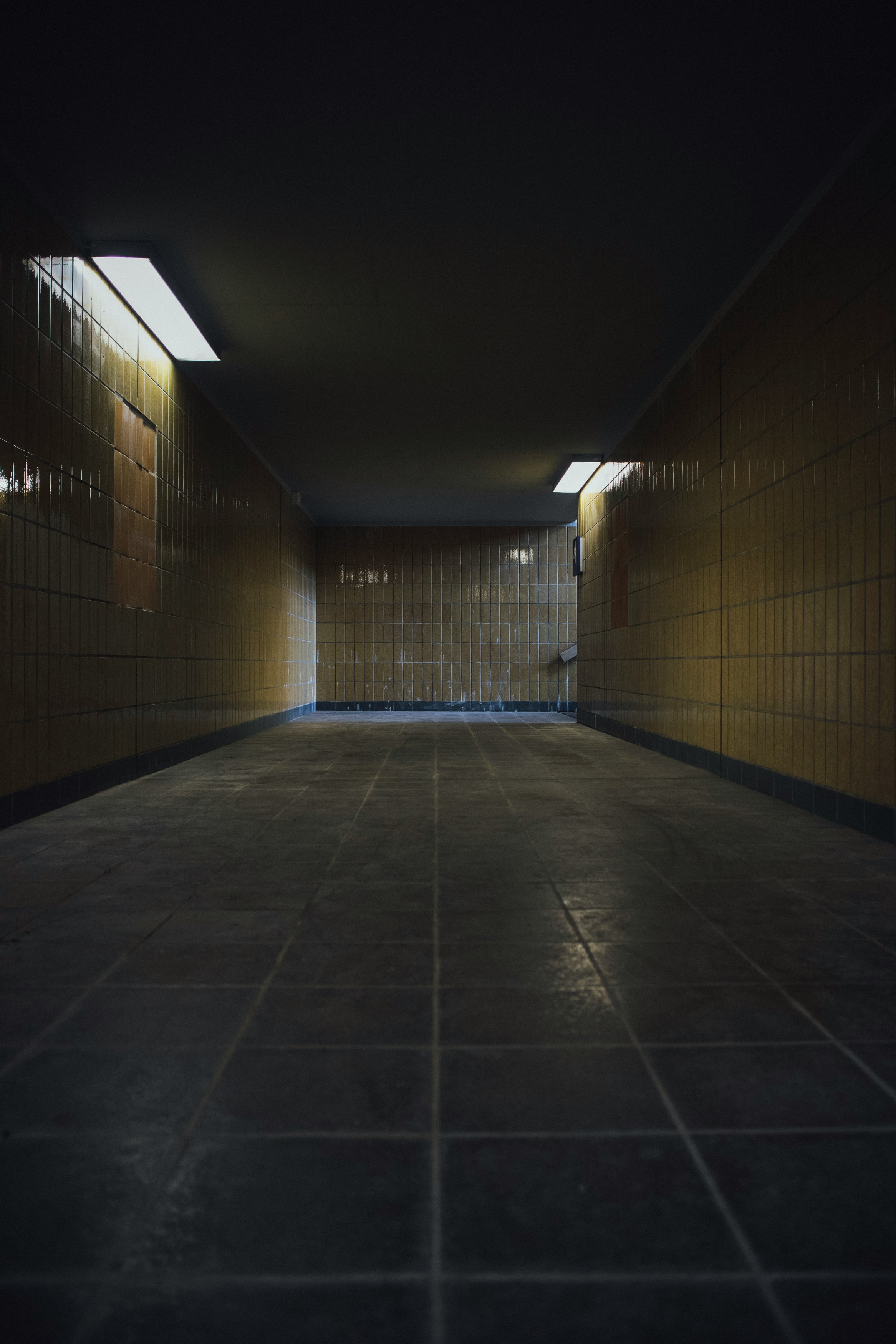 brown and white tiled hallway